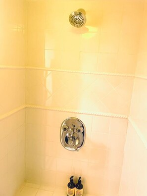 Rejuvenate in the tastefully tiled, two headed deluxe shower with massage shower nozzles.