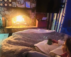 Light a fire and enjoy the custom build round bed.