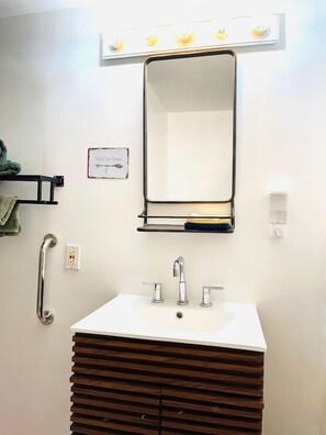 In the bathroom, you'll have a bathtub/shower cabin next to a modern sink and toilet.