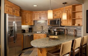 Fully equipped kitchen with modern appliances and a breakfast table.