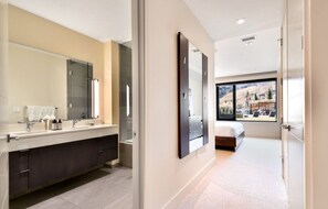 Spacious bathroom with dual vanities and elegant lighting.