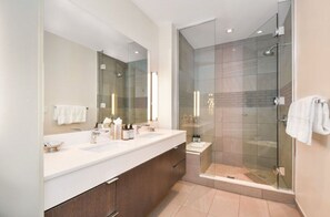 Modern bathroom featuring a walk-in shower and sleek design.