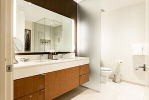 Spacious bathroom with a large mirror and modern fixtures.