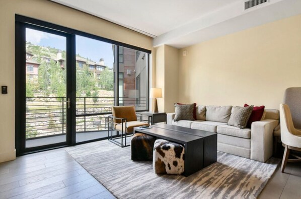 Bright living area with large windows and stylish decor.