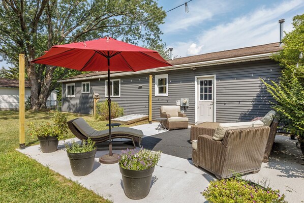 A serene backyard retreat featuring lush greenery and a tranquil atmosphere, perfect for relaxation and enjoying nature.