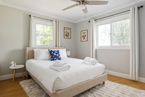 A cozy bedroom with a hint of vintage charm and a soothing atmosphere, ideal for unwinding and recharging.