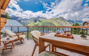 Soak up the sun and fresh mountain air on this spacious balcony, offering unparalleled views of the rolling hills.