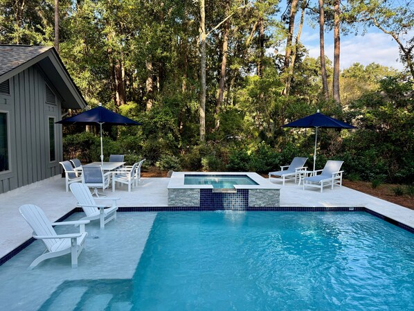 Enjoy a beautiful pool and spa, with multiple seating areas and a glimpse of the Heron Pointe golf course.