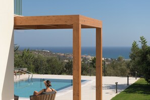 Relax by the pool with panoramic sea views as your backdrop.