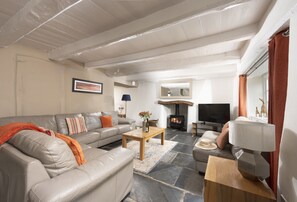 The Old Farmhouse, Duloe, Liskeard. Ground Floor: The characterful sitting room offers the warmth of a wood burning stove