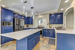 [Full Kitchen]
• Cups top left cabinet next to sink
• Stove vent behind arch