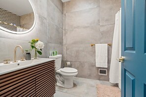Step into a contemporary bathroom that exudes luxury and style. You will appreciate the spacious shower, modern fixtures, and thoughtful touches that enhance your stay.