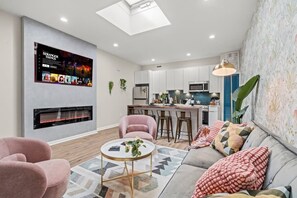 Immerse yourself in our chic living room! You will love the modern decor, cozy seating, and entertainment options. The perfect spot to unwind after a day of exploring.