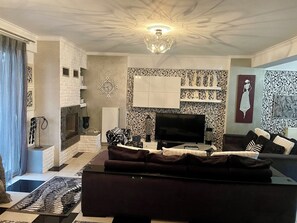 seventy square meters living room with dining room and fireplace.