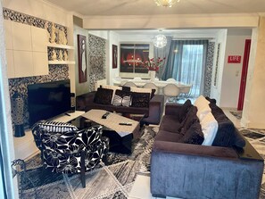 seventy square meters living room with dining room and fireplace.