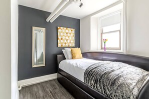 Cozy Space Featuring A Comfortable Sofa Bed And Ample Light