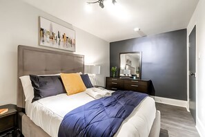 Cozy Bedroom With A Queen Bed, Modern Decor, And Plenty Of Storage Space