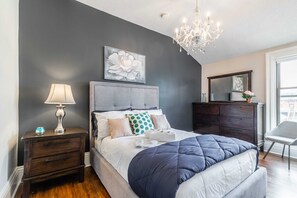 Cozy And Sophisticated Bedroom Featuring A Comfortable Queen Bed