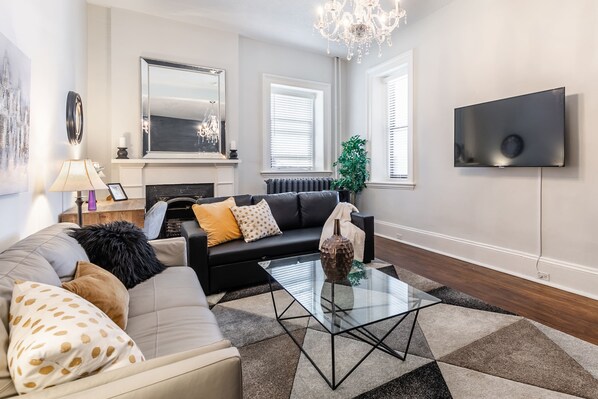 Spacious Living Room With Smart TV And Cozy Fireplace