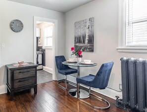 Cozy Dining Area With Elegant Blue Chairs And Artful Decor