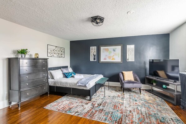 Spacious Bedroom With Stylish Decor And Smart TV