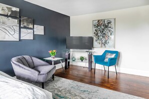 Stylish Sitting Area With Smart TV And Modern Art Accents