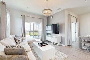 Relax in style in a spacious living room designed for comfort and entertainment.