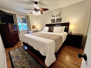 Master bedroom w/ king size bed, big screen TV w/ office workspace