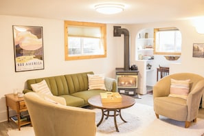 Bright and open living room with a couch that turns into a fold-out bed.