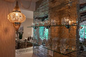 Antique mirrored bar area enlightened by handmade Morracan fixture