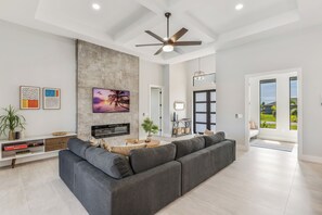 Living room facing wall mounted TV and electric fireplace