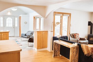 A view of the front door and dining room from the living room