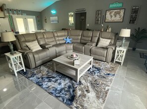 Enjoy leather reclining sectional w/ 60" Smart TV, and charging USB in tables.