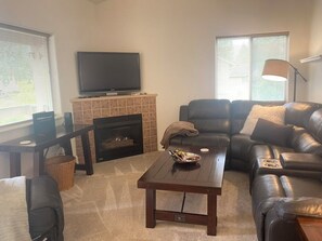 Relax in the living area with a Smart TV and a warm fireplace.