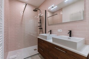 Bathroom with double sink and walk-in shower
