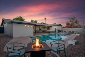 Savor the beauty of the sunset from the cozy glow of our backyard firepit