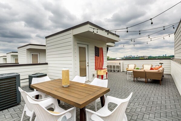 Unit 1: Private rooftop patio with dining, large flat screen TV and multiple lounge area