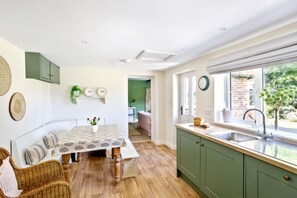 Gather around the dining table in the spacious kitchen – perfect for family meals and creating memories during your North Yorkshire getaway.
