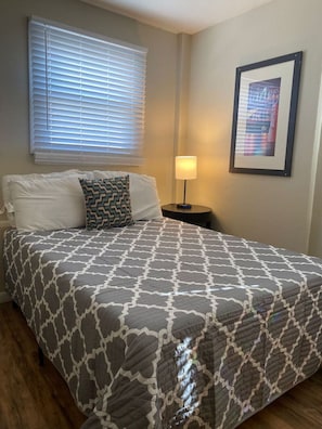 The room’s soft lighting and comfortable queen bed create a serene space perfect for relaxation and restful nights.