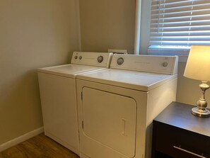 As you step into the laundry room, the modern appliances and ample storage space make it easy to keep things tidy.