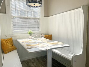 Elegant dining area with a large table and comfortable seating, perfect for gathering with family and friends for a meal.