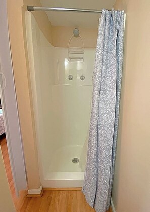 You feel a sense of calm as you enter the bathroom, where the thoughtful design and high-quality materials create a serene environment.