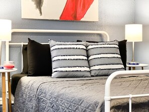 You feel enveloped in comfort as you relax on the queen bed, surrounded by a room designed for tranquility.