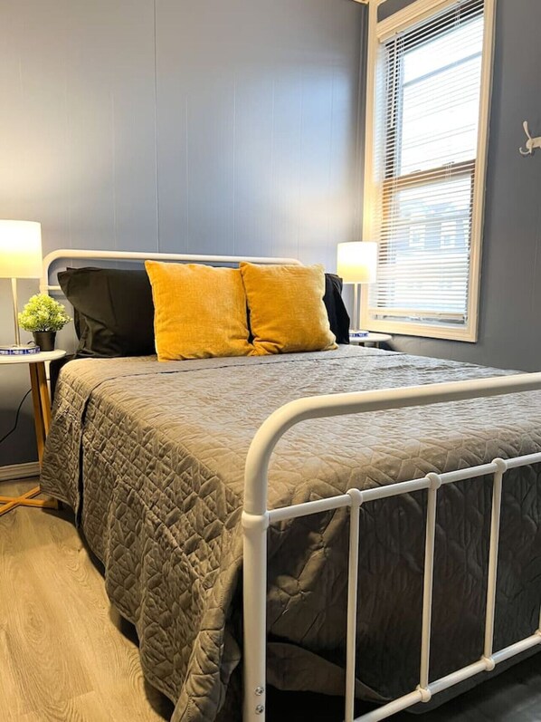 The bedroom’s serene ambiance invites you to relax, with a plush bed that promises a restful night's sleep.