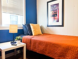 The twin bedroom serene ambiance invites you to relax, with a plush bed that promises a restful night's sleep.