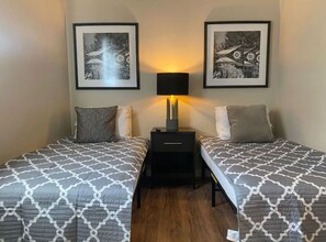 The bedroom’s serene ambiance invites you to relax, with a plush bed that promises a restful night's sleep.