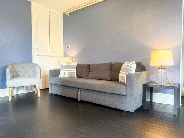 The living room’s cozy vibe makes it the perfect spot to relax, with ample seating and a warm ambiance.