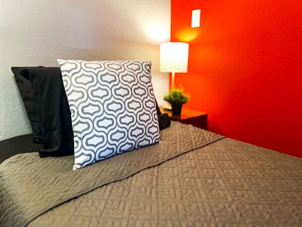 The twin bedroom serene ambiance invites you to relax, with a plush bed that promises a restful night's sleep.