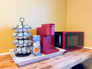 The coffee station is thoughtfully equipped with a variety of in-house consumables, including a selection of ground coffee, sweeteners, and creamers to suit every taste.