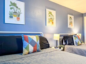 The room’s soft lighting and comfortable queen bed create a serene space perfect for relaxation and restful nights.
